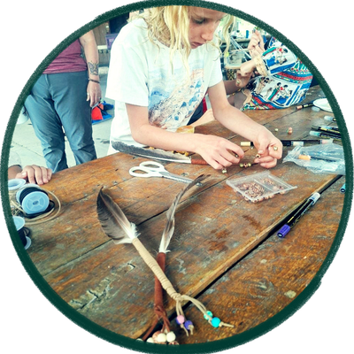 A child building a crystal wand at Kids' Camp